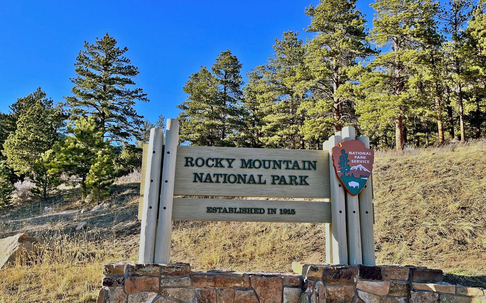 Rocky Mountain National Park Sign on a sunny day with clear sky overhead